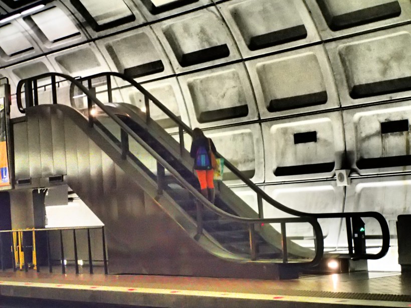 Red pants on escalator.