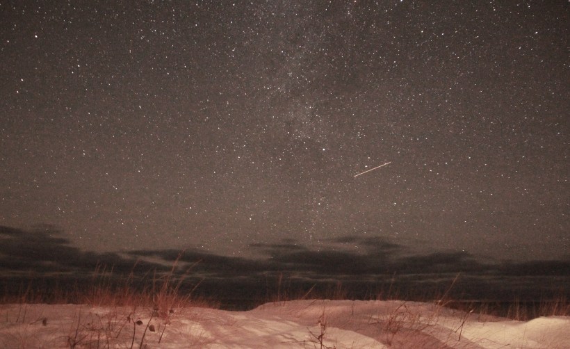 Low dunes, clouds on the horizon and maybe a plane.  Oh..and stars.