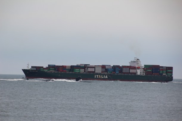 That's a submarine in front of that ship!