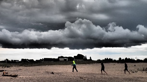 Kids heading out to witness the storm.  And collect rocks.