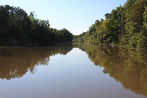 The river mirrors the weather.