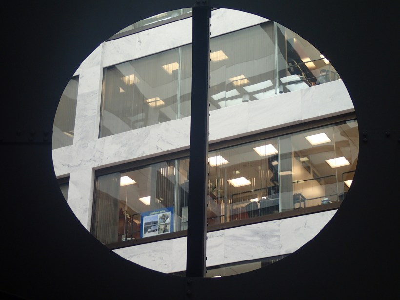Hart Senate Office Building windows  framed by an art installation in the lobby.