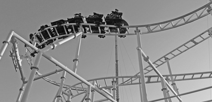 Humans ride through the air on a man made roller coaster.